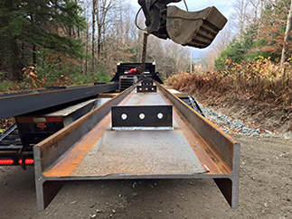 Aardvark Excavating putting a steal beam in place on a bridge construction project in Stowe, VT. 