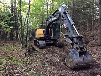 One of Aardvark's excavators clearing a roadway on a commercial excavation project in Stowe, VT. 